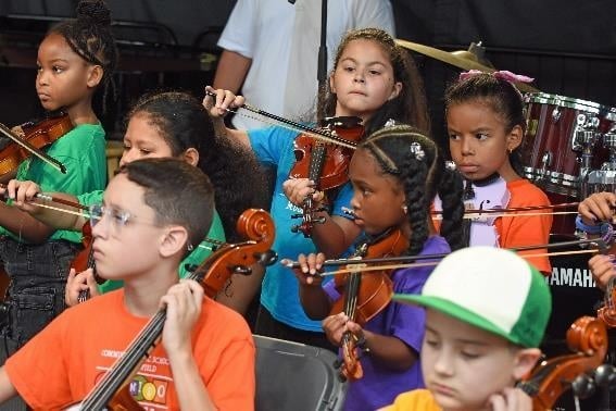 Young string musicians performing together
