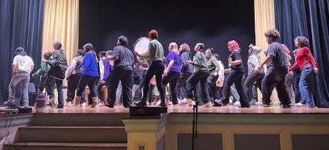 Students performing together on stage during the Legacy Education Project